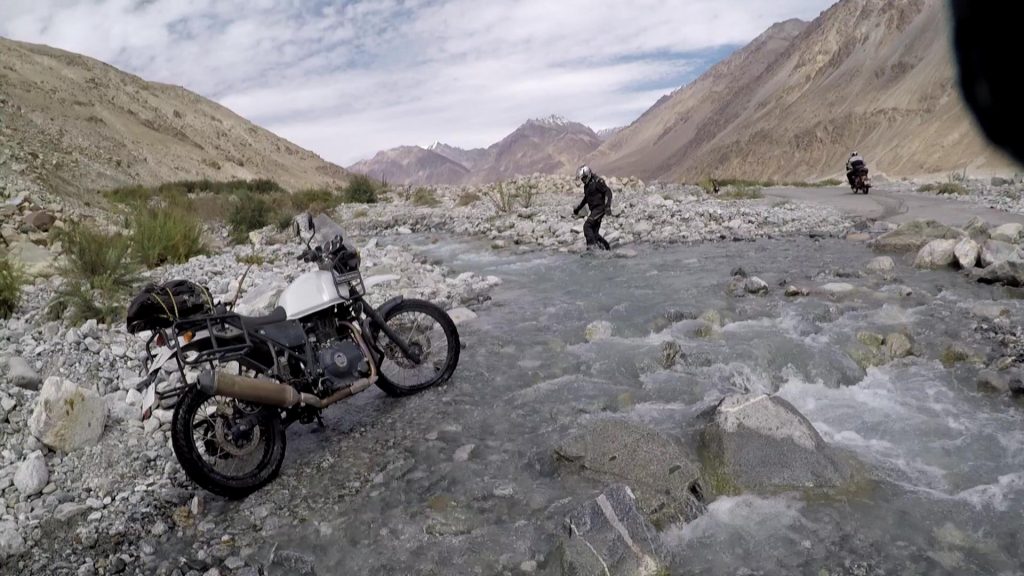 Biker Crossing a water stream